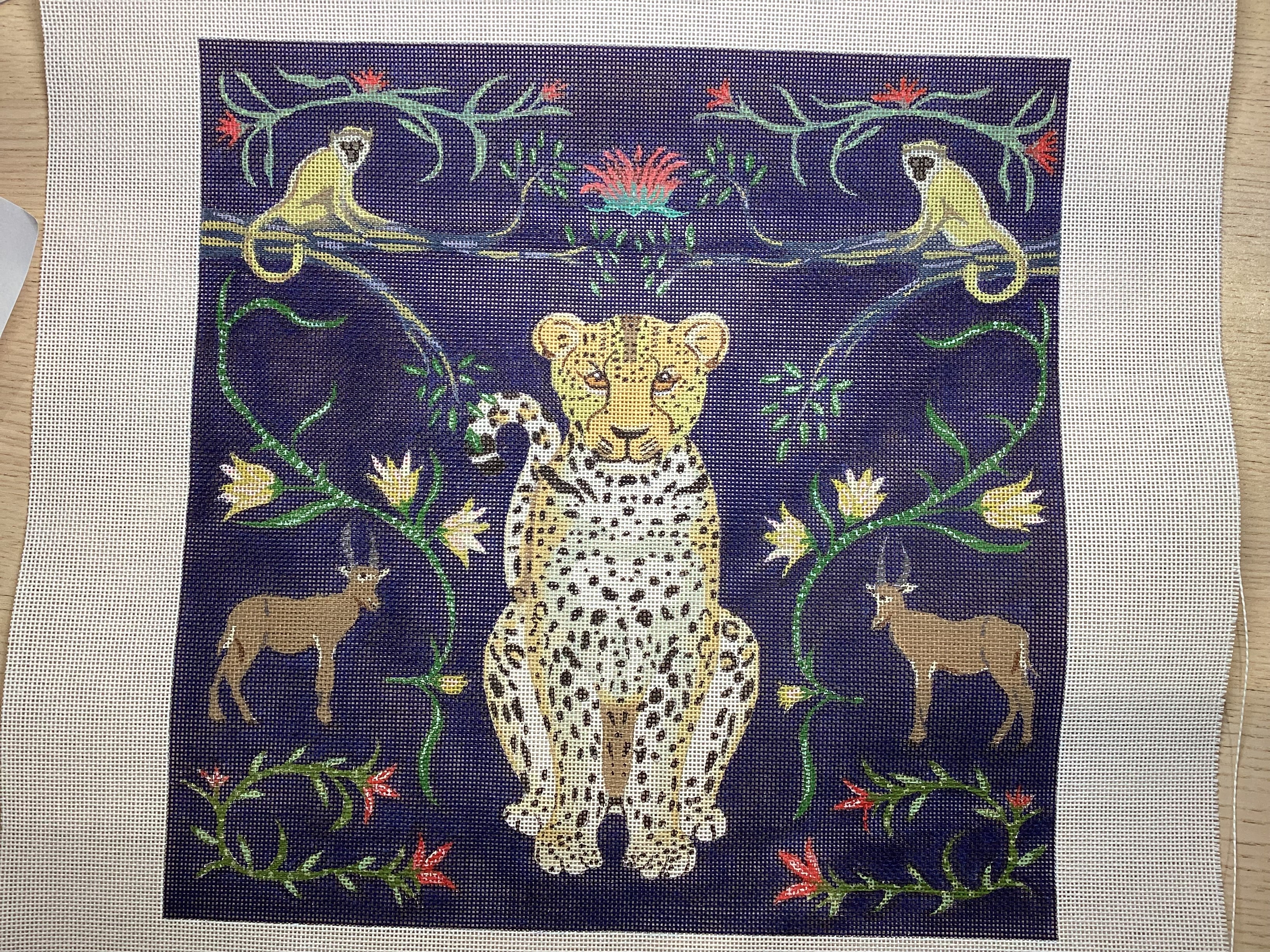 Leopard with navy background and florals and gazelle