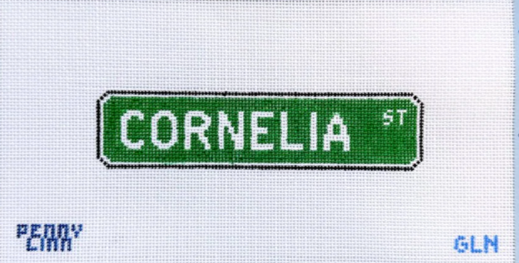 Green street sign with 'Cornelia St' text on a white background needlepoint canvas