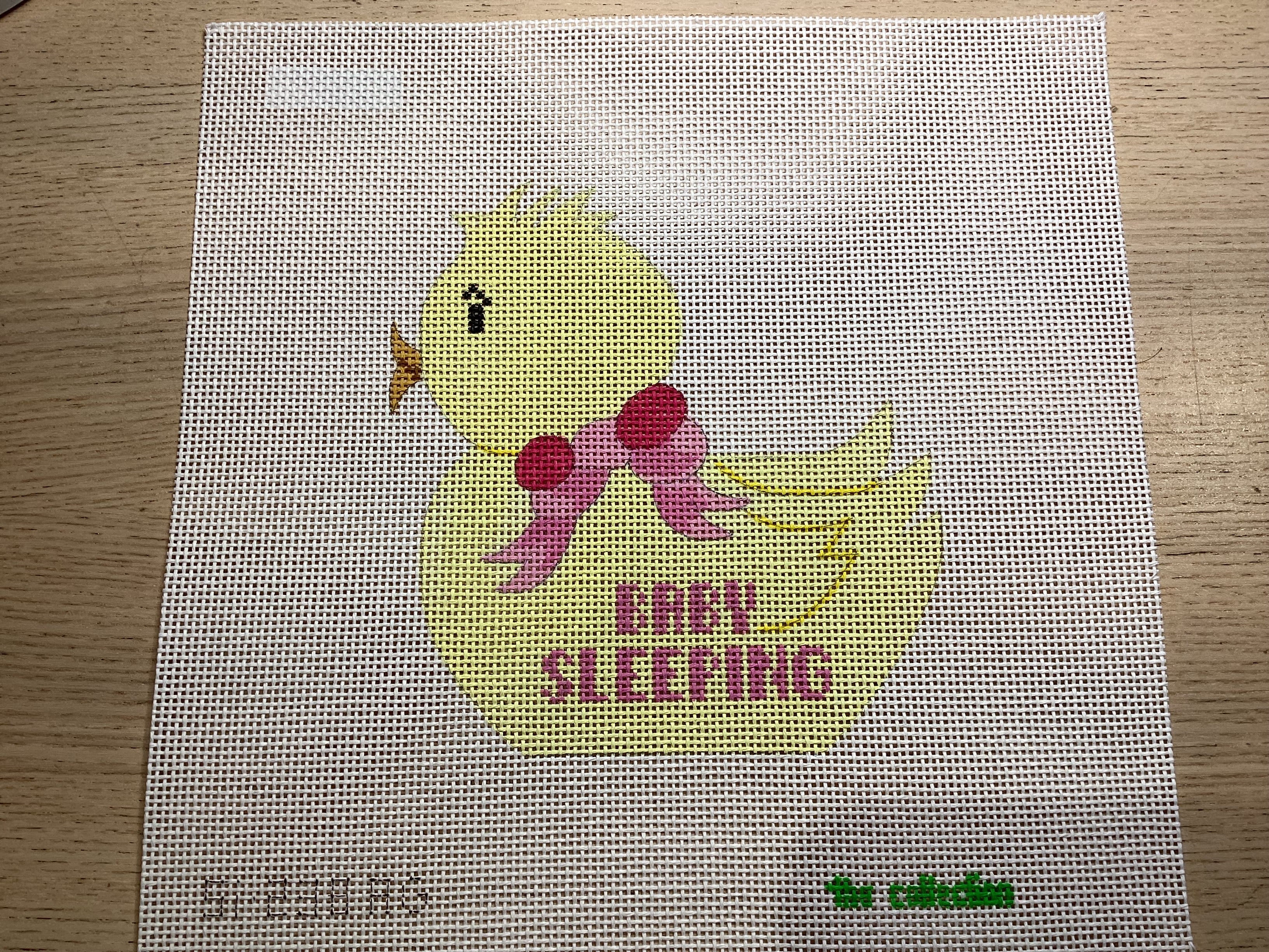 Pink baby sleeping on yellow duck
